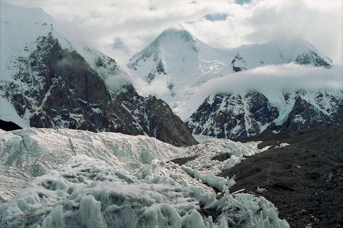 16 Gasherbrum I and Gasherbrum I South From Abruzzi Glacier The next morning we started our trek to Gasherbrum base camp in mostly cloudy weather. After 30 minutes we reached �Gasherbrum Corner� at the junction of the Upper Baltoro Glacier with the tributary Abruzzi Glacier. Gasherbrum I and Gasherbrum I South lie straight ahead. Gasherbrum I (8080m) is the 11th highest mountain in the world. Gasherbrum I was first climbed by July 5, 1958 by Americans Pete Schoening and Andy Kauffman.